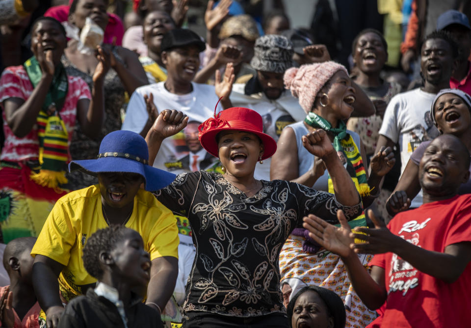 Members of the public sing as they gather in the stands for the funeral service of former president Robert Mugabe at the National Sports Stadium in the capital Harare, Zimbabwe Saturday, Sept. 14, 2019. African heads of state and envoys are gathering to attend a state funeral for Mugabe, whose burial has been delayed for at least a month until a special mausoleum can be built for his remains. (AP Photo/Ben Curtis)