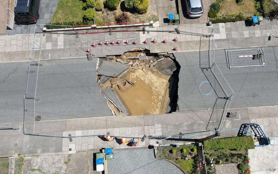 Thames Water And Council Workers At The Scene. - STEVE FINN 