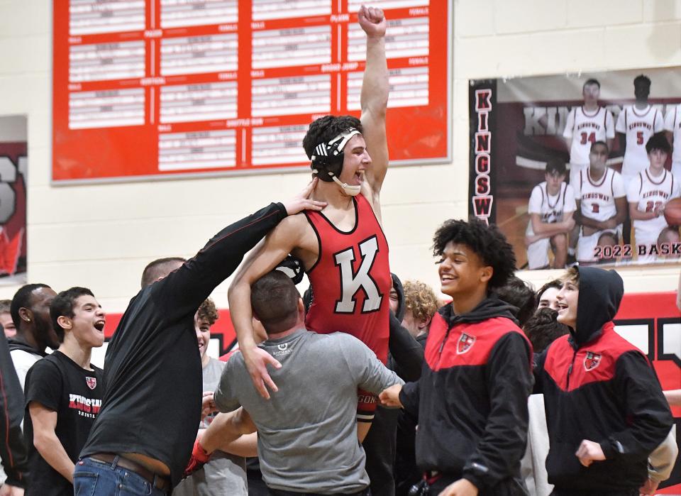 Kingsway's Brady Whitzell is hoisted into the air after defeating Jake Andre following Friday's wrestling match against St. Augustine. The Dragons defeated St. Augustine 37-33. Jan. 28, 2022.