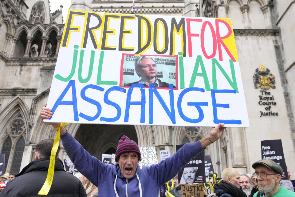 Demonstrators hold banners outside the Royal Courts of Justice in London, Tuesday, Feb. 20, 2024. WikiLeaks founder Julian Assange will make his final appeal against his impending extradition to the United States at the court. (AP Photo/Kirsty Wigglesworth)