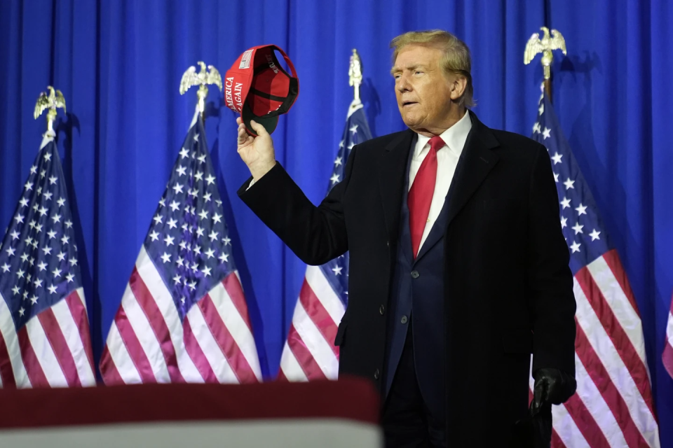 Republican presidential candidate and former President Donald Trump tips his hat at a campaign rally in Waterford Township, Mich., Saturday, Feb. 17, 2024. (AP Photo/Paul Sancya)