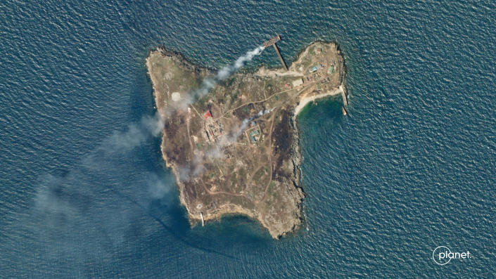A satellite image shows smoke rising from Snake Island