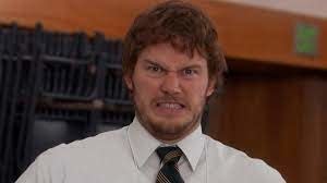 Chris Pratt's character in a scene from Parks and Rec grimacing