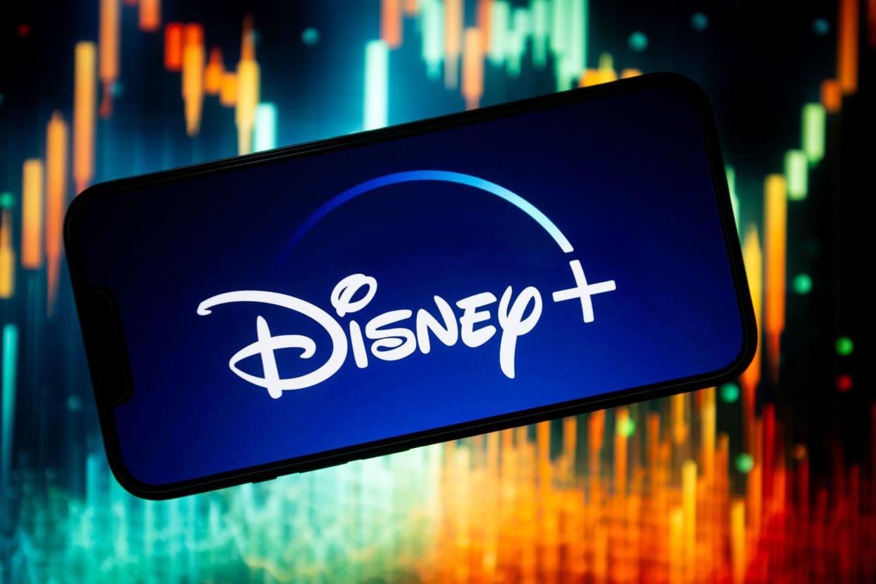 In this photo illustration, a Disney + logo seen displayed on a smartphone.