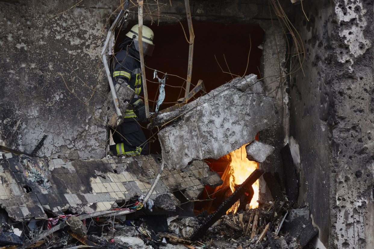 Firemen extinguish a fire inside a residential building that was hit by a missile on Feb. 25, 2022, in Kyiv, Ukraine.