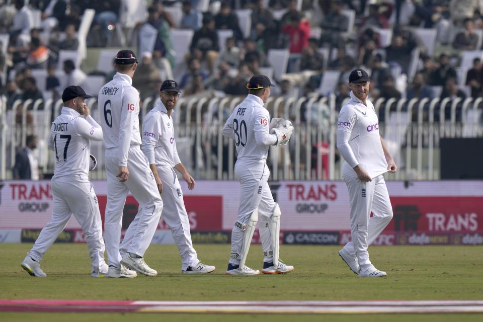 England's skipper Ben Stokes, right, and teammates walk off the field on the lunch break during the second day of the first test cricket match between Pakistan and England, in Rawalpindi, Pakistan, Friday, Dec. 2, 2022. (AP Photo/Anjum Naveed)