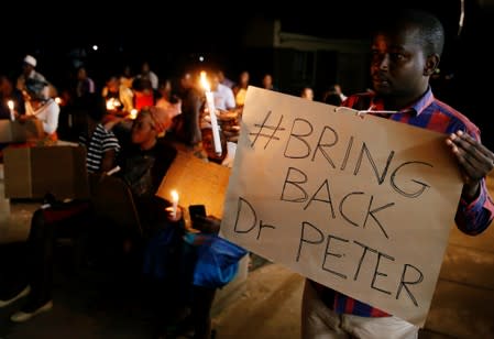 Zimbabwean healthcare workers hold a candlelight vigil to protest over the disappearance of Peter Magombeyi, the leader of their union in Harare