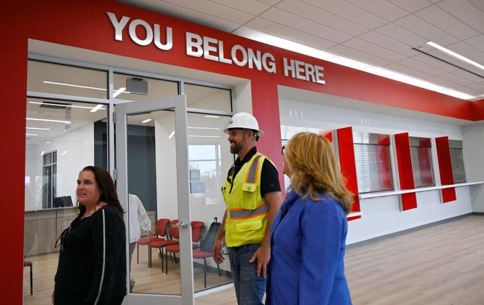 Administrators walk past service windows during a tour of Fresno City College’s new west Fresno campus still under construction on Thursday, June 22, 2023.