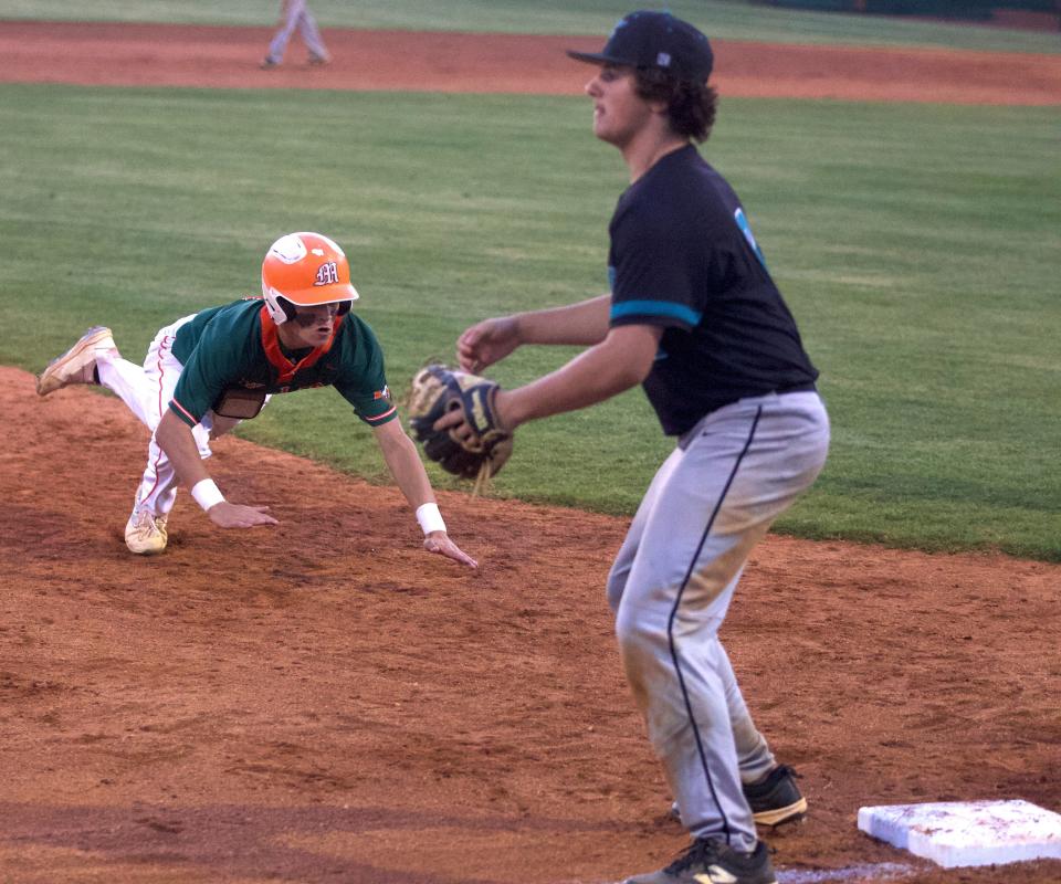 An East Lincoln runner prepares the slide headfirst into third base during his team's 3A first round baseball playoff matchup against Forestview on Tuesday, May 10, 2022.