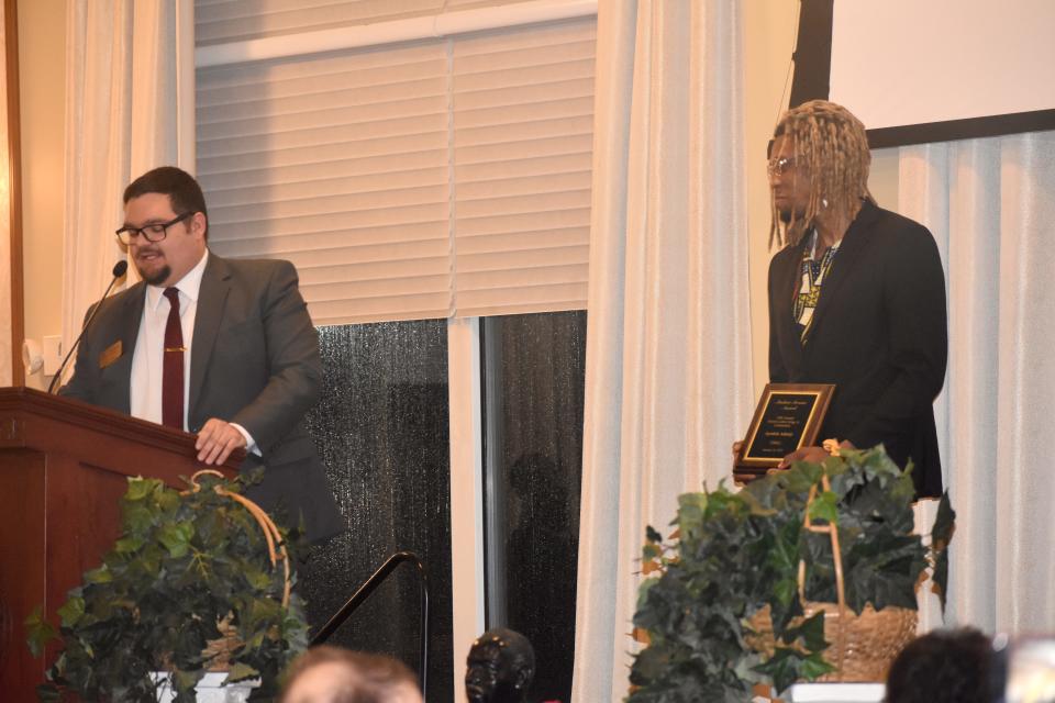 Adrian College Dean of Students and Dean of Student Affairs Thomas Doney, left, introduces junior Ayodele Adeniye as Adrian College's Student Service Award recipient during Lenawee County's annual Martin Luther King Jr. Community Celebration and Dinner Monday, Jan. 16, 2023, on the campus of Adrian College.