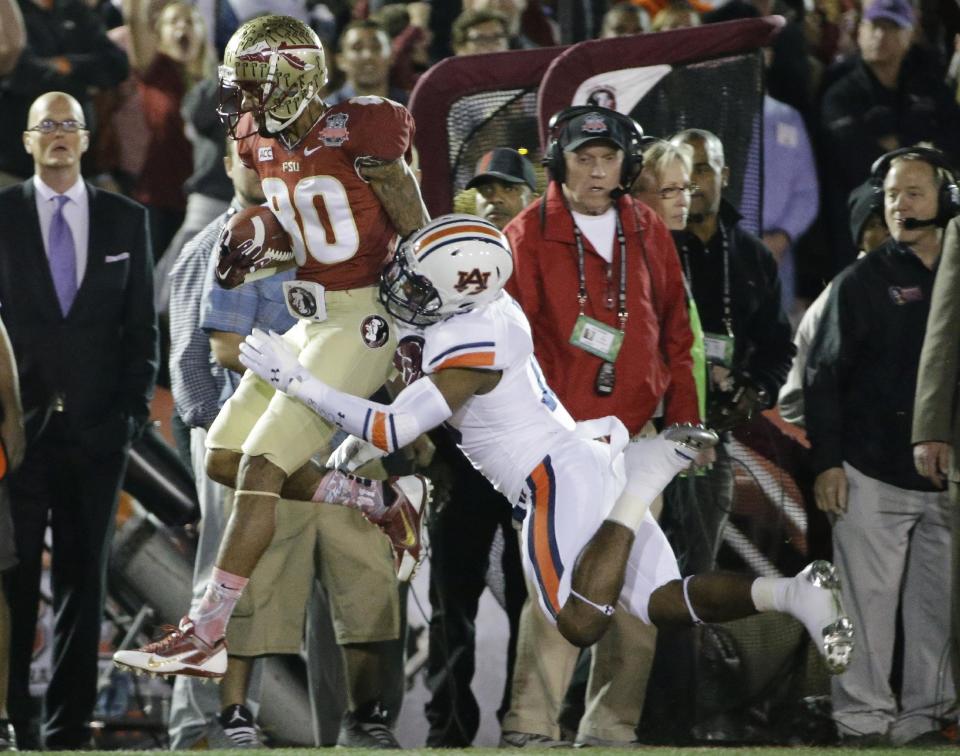 Florida State's Rashad Greene catches a pass in front of Auburn's Ryan White (19) during the first half of the NCAA BCS National Championship college football game Monday, Jan. 6, 2014, in Pasadena, Calif. (AP Photo/David J. Phillip)