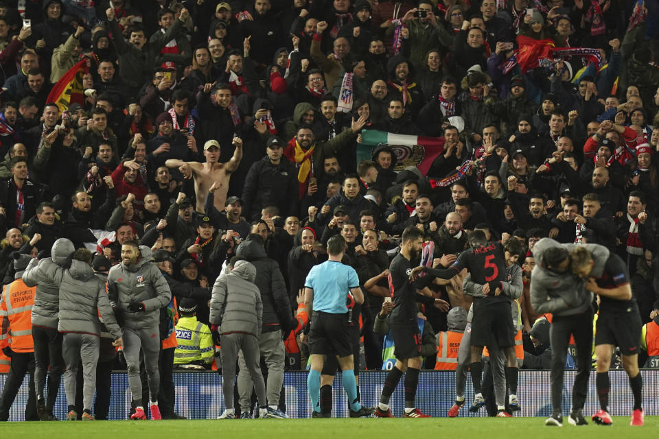 Atletico Madrid players celebrate at the end of the second leg, round of 16, Champions League soccer match between Liverpool and Atletico Madrid at Anfield stadium in Liverpool, England, Wednesday, March 11, 2020. (AP Photo/Jon Super)