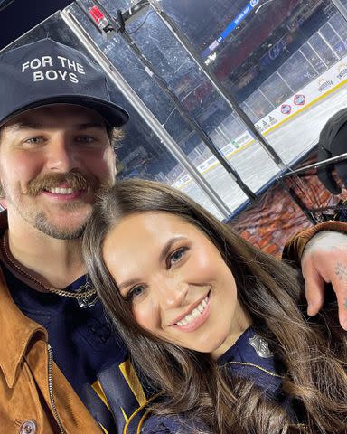 <p>Taylor Lewan Instagram</p> Taylor Lewan at a hockey game with his wife Taylin Lewan.