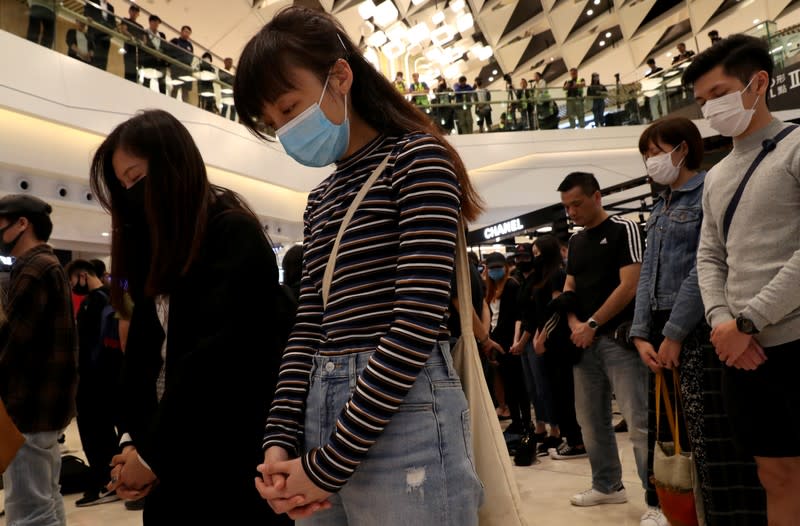 Protesters hold a minute of silence during an anti-government protest at Yoho Mall in Yuen Long, Hong Kong