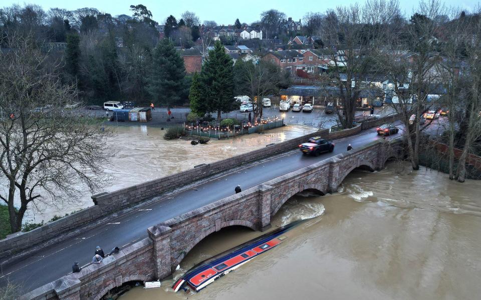 A narrow boat sinks after breaking from its mooring during flooding on the River Soar in Leicestershire