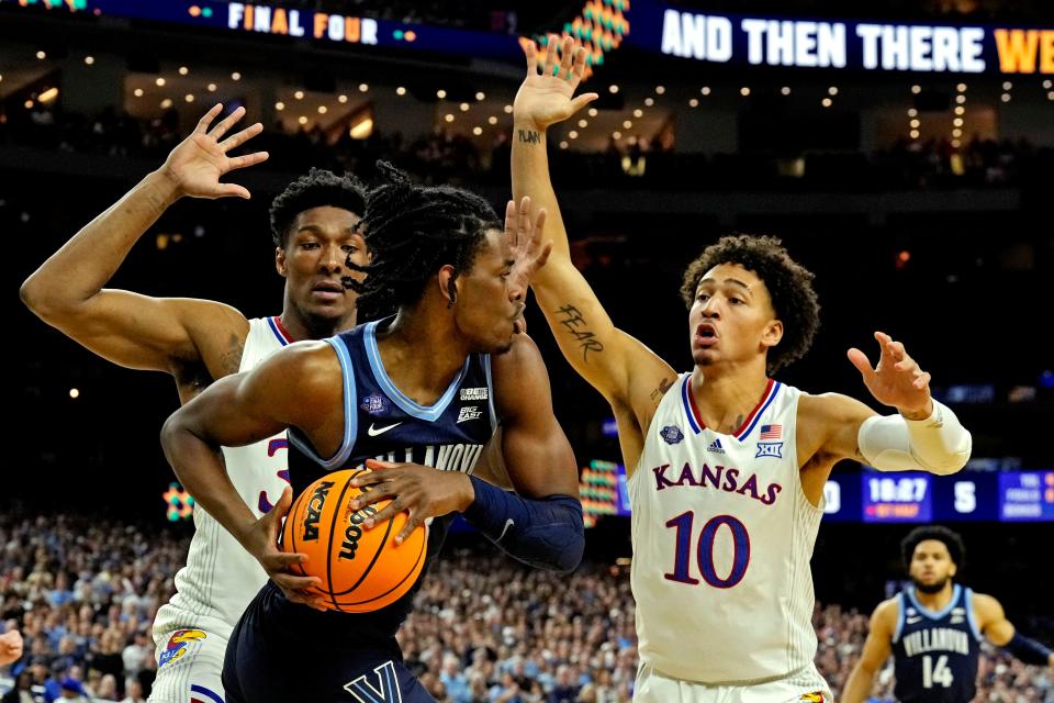 Villanova forward Brandon Slater (3) handles the ball against Kansas forwards David McCormack (33) and Jalen Wilson (10) during a Final Four game at the NCAA tournament on April 2, 2022, in New Orleans.