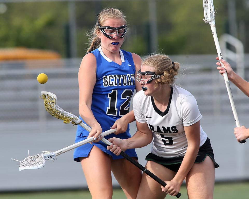 Scituate's Casey McKeever knocks the ball out of the cradle of Marshfield's Julia O'Brien during second-half action at Marshfield High on Tuesday, May 16, 2023.