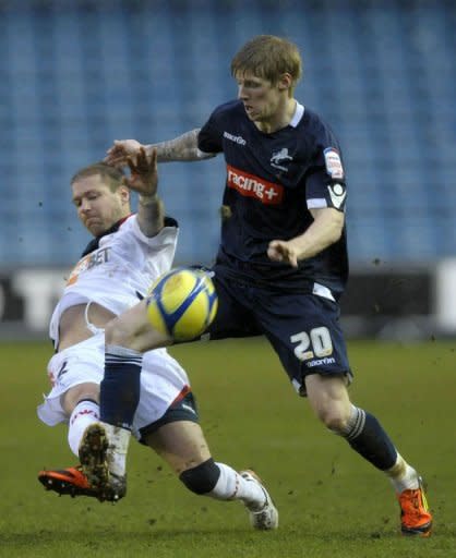 Millwall's striker Andy Keogh (R) clashes with Bolton Wanderers' defender Gretar Rafn Steinsson during the English FA Cup 5th Round football match at The Den in South London