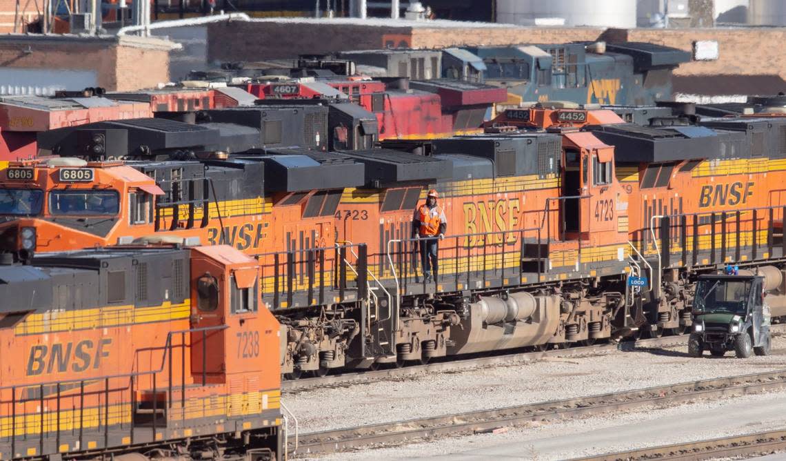 A railroad worker walks on a locomotive engine last month at the BNSF Railway Argentine Yard in Kansas City, Kansas. 