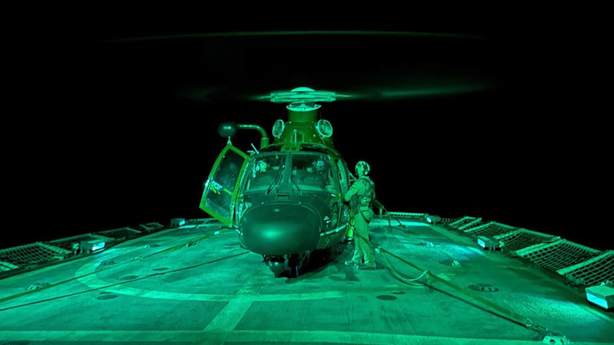 <div>An aircrew from the Helicopter Interdiction Squadron (HITRON) aboard an MH-65 Dolphin performs night vision goggle deck landing qualifications aboard the USCGC Active (WMEC 618) while patrolling the Eastern Pacific Ocean. (Photo: U.S. Coast Guard)</div>