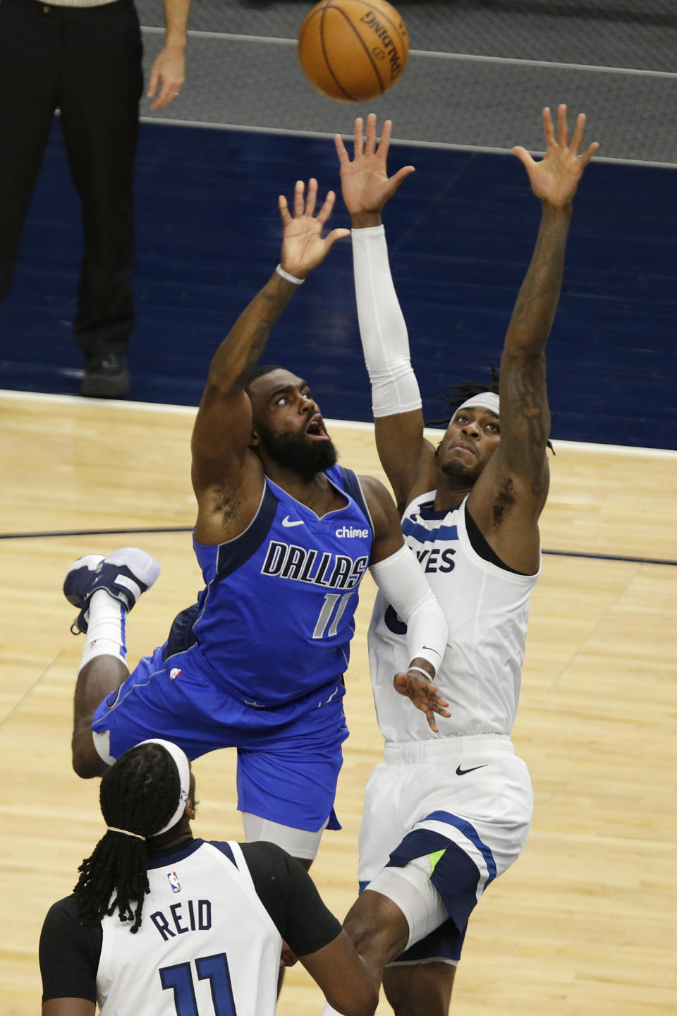 Dallas Mavericks forward Tim Hardaway Jr. (11) shoots in front of Minnesota Timberwolves forward Jarred Vanderbilt (8) in the second quarter during an NBA basketball game, Sunday, May 16, 2021, in Minneapolis. (AP Photo/Andy Clayton-King)