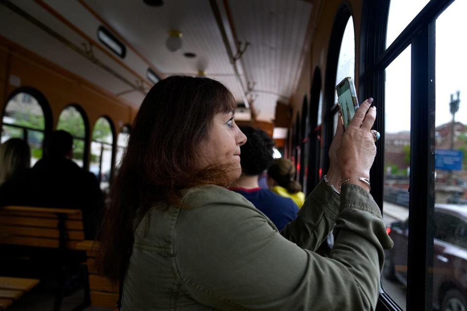 Odette Safarian, visiting Rhode Island from California, takes a photo of one of Providence's many murals from the Gallery Night trolley.