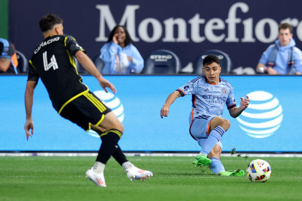 Jun 14, 2024; Bronx, New York, USA; New York City FC forward Agustin Ojeda (26) passes the ball against Columbus Crew defender Rudy Camacho (4) during the first half at Yankee Stadium. Mandatory Credit: Brad Penner-USA TODAY Sports