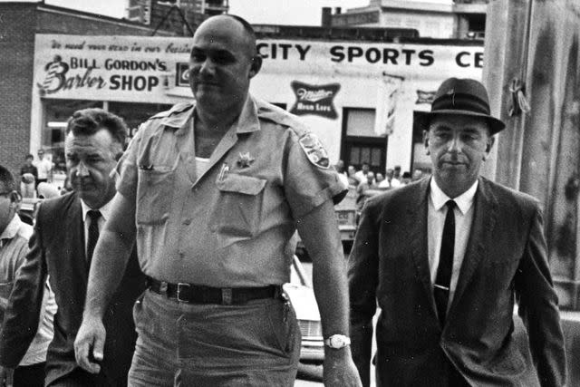 <p>FBI</p> FBI agents escort Sheriff Lawrence Rainey to court in October 1964.