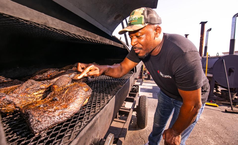 Rashad Jones checks out a smaller brisket in his smoker.