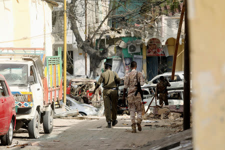 Security personnel walk at the scene where a suicide car bomb exploded targeting a Mogadishu hotel in a business center in Maka Al Mukaram street in Mogadishu, Somalia March 1, 2019. REUTERS/Feisal Omar