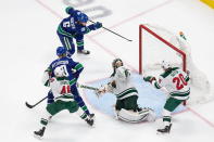 Minnesota Wild goaltender Alex Stalock (32) can't stop Vancouver Canucks' Brock Boeser (6) from scoring during the second period of an NHL hockey playoff game in Edmonton, Alberta, Tuesday, Aug. 4, 2020. (Codie McLachlan/The Canadian Press via AP)