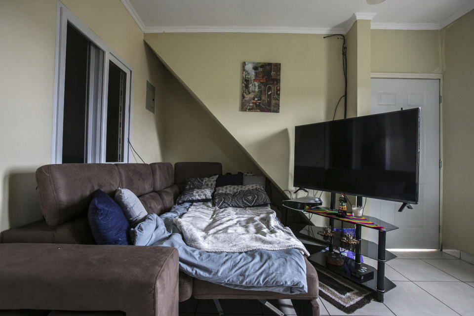 A sofa bed stands in the living room of a woman who guided her friend through an abortion, one year prior, in an undisclosed town of Honduras, Monday, March 20, 2023. Four years earlier, the home owner discovered that her own mother was part of the clandestine abortion network when she herself sought help to get one. (AP Photo/Ginnette Riquelme)