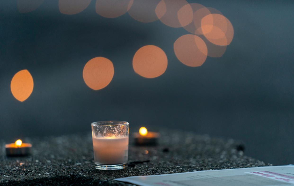 Candles are placed around the fountain on Haynie’s Corner during a vigil for abortion rights in Indiana in Evansville, Ind., Tuesday, Aug. 1, 2023.