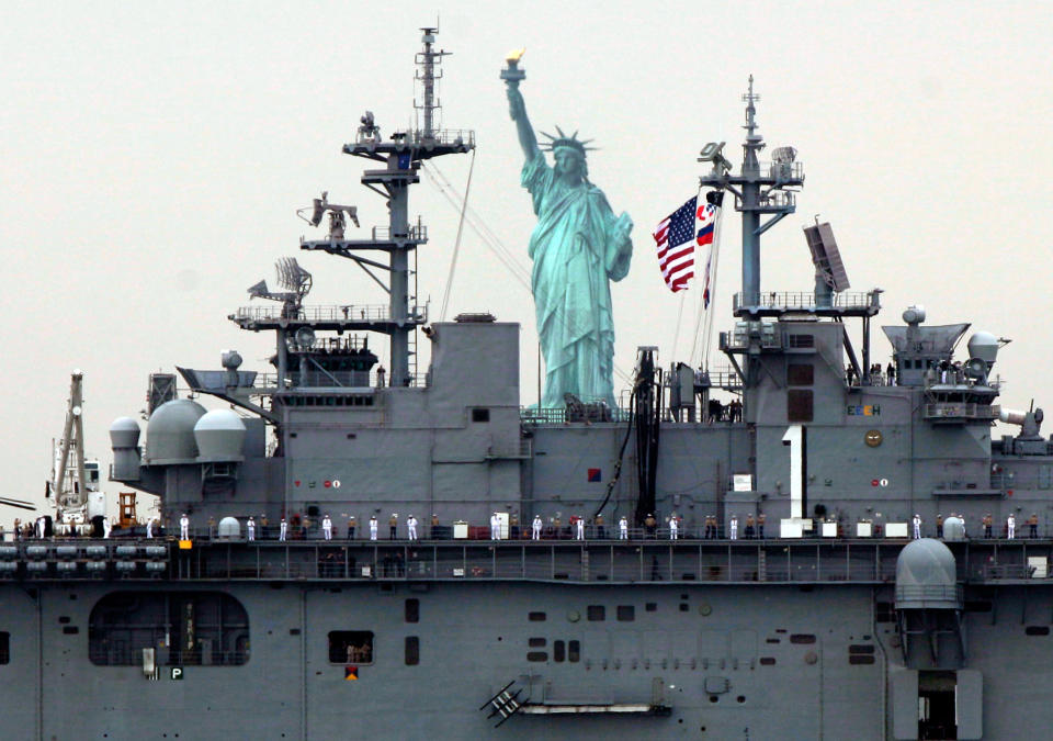 Sailors line the deck of the USS Wasp as she sails by the Statue Of Liberty, in New York, to participate in Fleet Week activities, Wednesday, May 23, 2012. (AP Photo/Richard Drew)