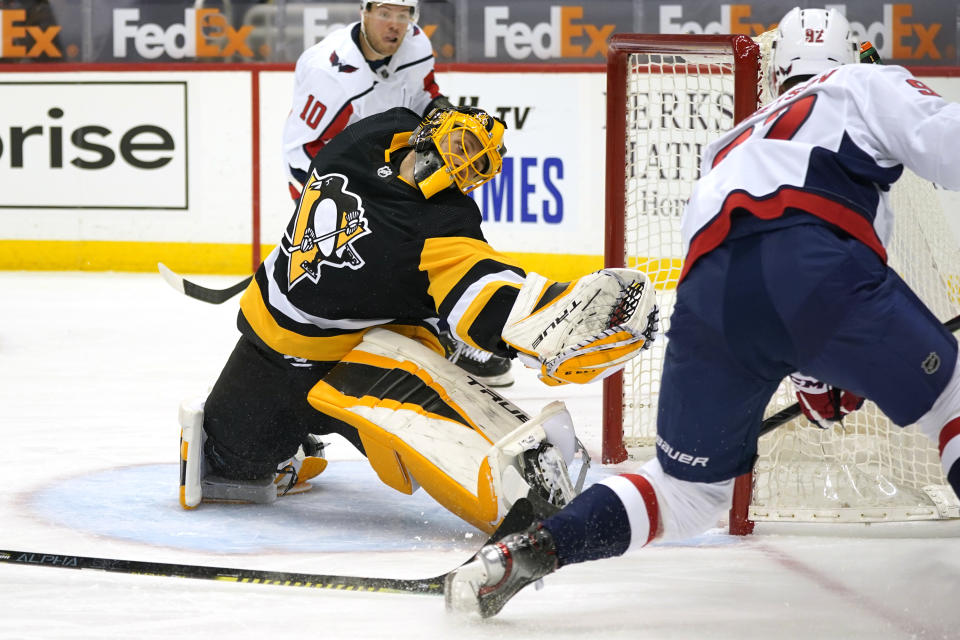 Washington Capitals' Evgeny Kuznetsov (92) scores against Pittsburgh Penguins goaltender Casey DeSmith during the second period of an NHL hockey game in Pittsburgh, Tuesday, Jan. 19, 2021. The Penguins won 5-4 in overtime. (AP Photo/Gene J. Puskar)