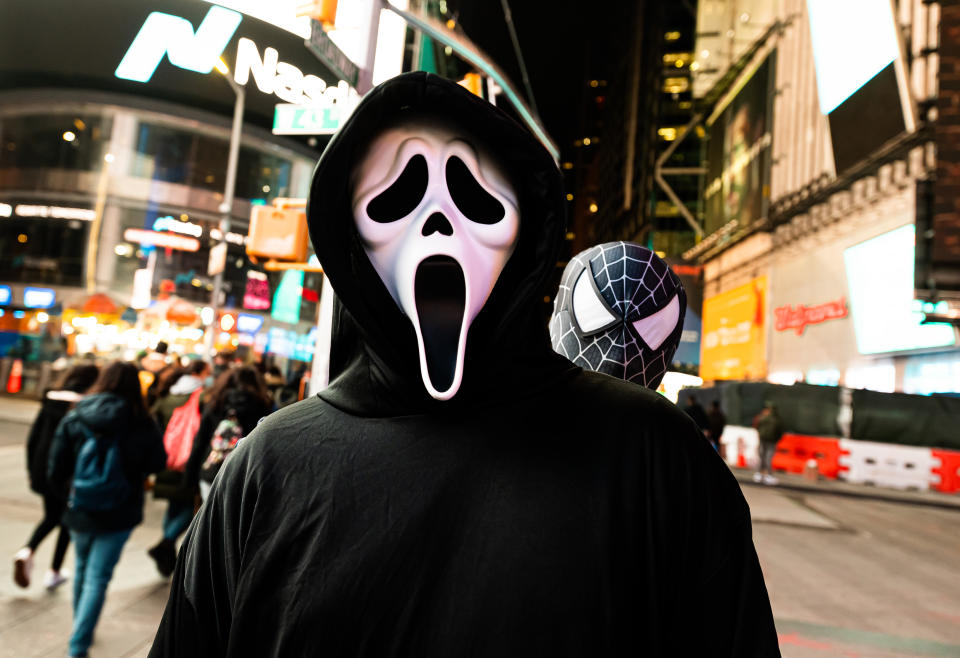 A person wears a Ghostface costume from the movie 'Scream' in Times Square on October 31, 2020 in New York City. (Photo by Noam Galai/Getty Images)