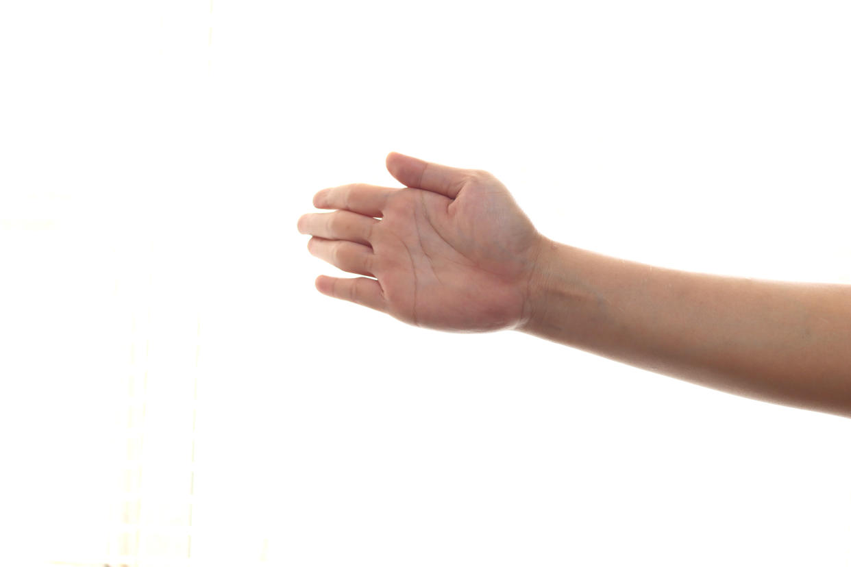 Hand of a person slapping gesture, isolated on white background