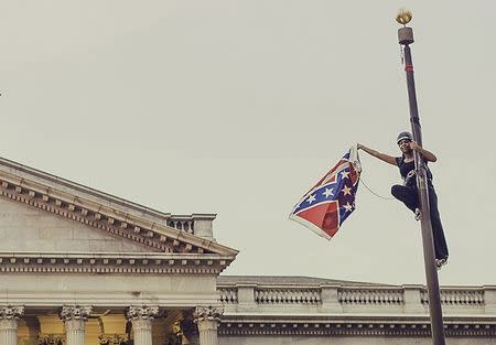 Bree Newsome takes down the Confederate Flag from a pole at the Statehouse in Columbia, South Carolina, June 27, 2015. REUTERS/Adam Anderson Photo