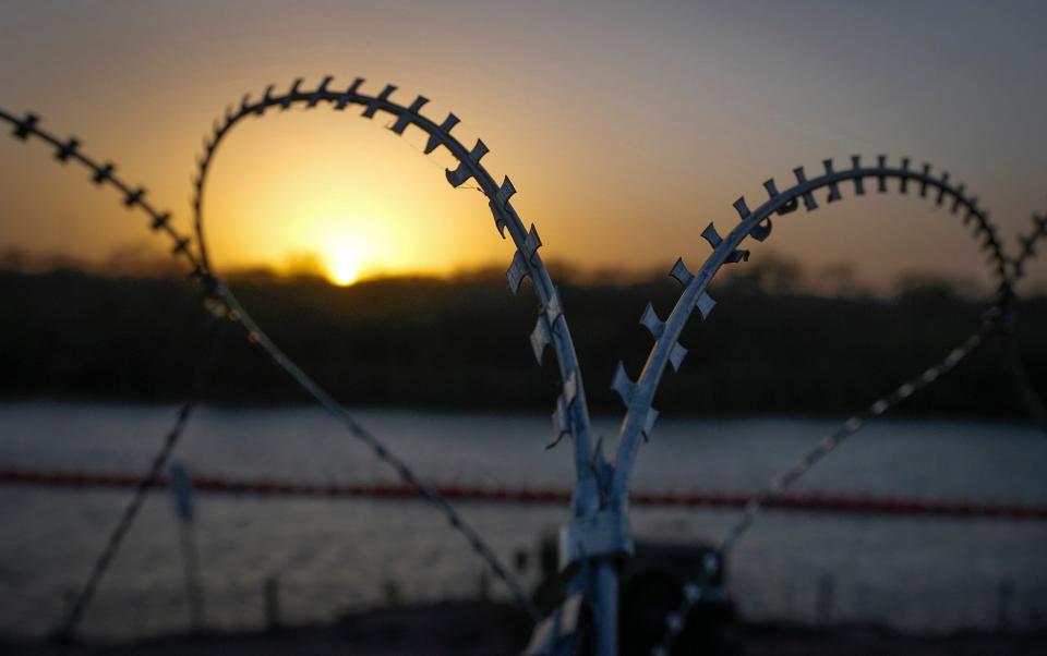 A buoy barrier in the Rio Grande and razor wire protect the U.S. border in Eagle Pass on Monday January 8, 2024.