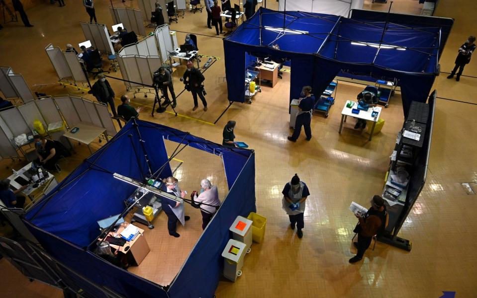 Staff give Covid jabs to patients at a vaccination centre in the Bournemouth International Centre - Glyn Kirk/AFP