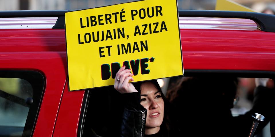Demonstrator from Amnesty International holds placard outside the Saudi Arabian Embassy to protest on International Women's day to urge Saudi authorities to release jailed women's rights activists Loujain al-Hathloul, Eman al-Nafjan and Aziza al-Yousef in Paris, France, March 8, 2019. The placard reads: "Freedom for Loujain, Aziza and Iman". REUTERS/Benoit Tessier