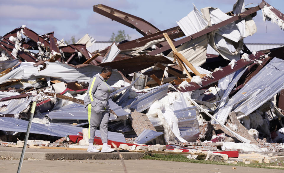 Adela Cox looks at the Trinity Baptist Church that was destroyed by a tornado in Idabel, Okla., Saturday, Nov. 5, 2022. (AP Photo/LM Otero)