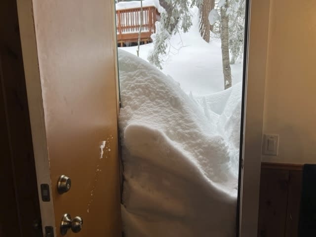 Snow blocks the kitchen doorway of Jennifer Cobb's house in Lake Arrowhead on Tuesday, Feb. 28, 2023 in the San Bernardino Mountains of San Bernardino County, Calif. Beleaguered Californians got hit again Tuesday as a new winter storm moved into the already drenched and snow-plastered state, with blizzard warnings blanketing the Sierra Nevada and forecasters warning residents that any travel was dangerous. (Jennifer Cobb via AP)