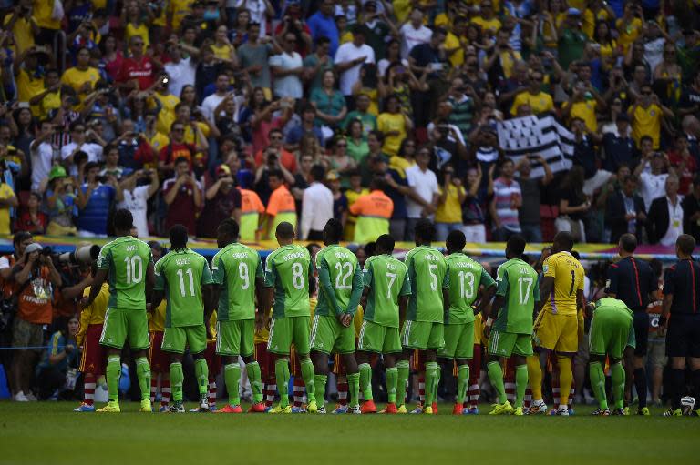 Nigeria players stand on the pitch prior to the match against France at Mane Garrincha National Stadium in Brasilia during the 2014 FIFA World Cup on June 30, 2014