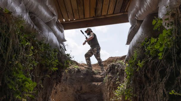 PHOTO: A fighter with Dnipro-1, a unit in Ukraine's National Guard, walks through a bunker position along the frontline outside of Sloviansk, Ukraine, Aug. 3, 2022. (David Guttenfelder/The New York Times via Redux)