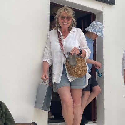 Fern Britton smiling in a linen shirt and denim shorts