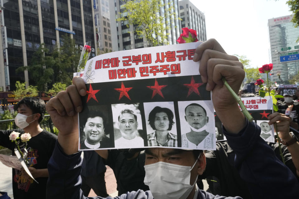 FILE - A Myanmar national living in South Korea attends a march to condemn Myanmar's recent executions of activists, at the down town in Seoul, South Korea, Saturday, July 30, 2022. The signs read: "We condemns the executions of the Myanmar military." Recent executions of four democracy activists in Myanmar have reenergized efforts to get the U.S. and other countries to impose further sanctions against military leaders who ousted its elected government early last year. (AP Photo/Ahn Young-joon, File)