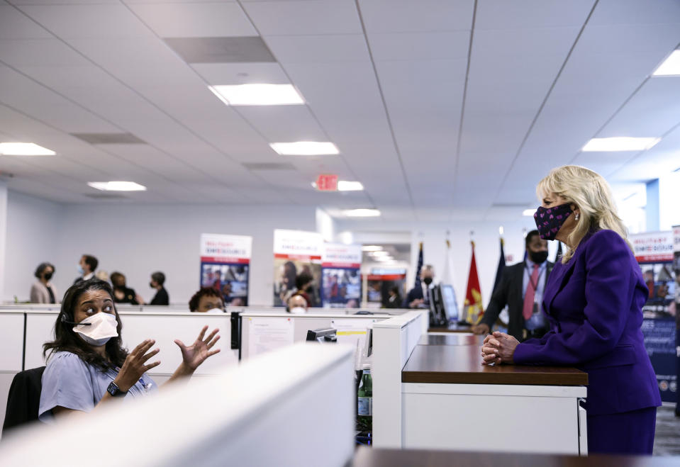 First lady Jill Biden listens to a staff member as she tours Military One Source, an active duty military resource hub/call center for service members, their family and survivors, in Arlington, Va, in Wednesday, April 7, 2021. In announcing the relaunch of Joining Forces, Biden said the initiative will focus on employment and entrepreneurship opportunities for military families, education for the more than 2 million children of enlisted parents and veterans, and the overall health and well-being of these families (Tom Brenner/Pool via AP)