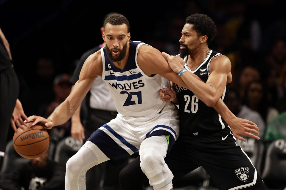 Minnesota Timberwolves center Rudy Gobert (27) drives to the basket against Brooklyn Nets guard Spencer Dinwiddie during the second half of an NBA basketball game, Tuesday, April 4, 2023, in New York. (AP Photo/Adam Hunger)