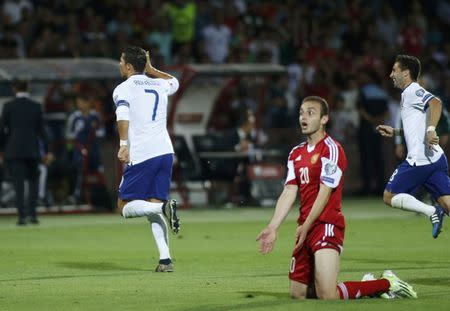 Portugal's Cristiano Ronaldo (L) celebrates after scoring the third goal against Armenia during their Euro 2016 group I qualifying soccer match in Yerevan, Armenia June 13, 2015. REUTERS/David Mdzinarishvili